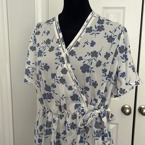 Sienna sky blouse. Floral and white . Faux wrap with tie attached